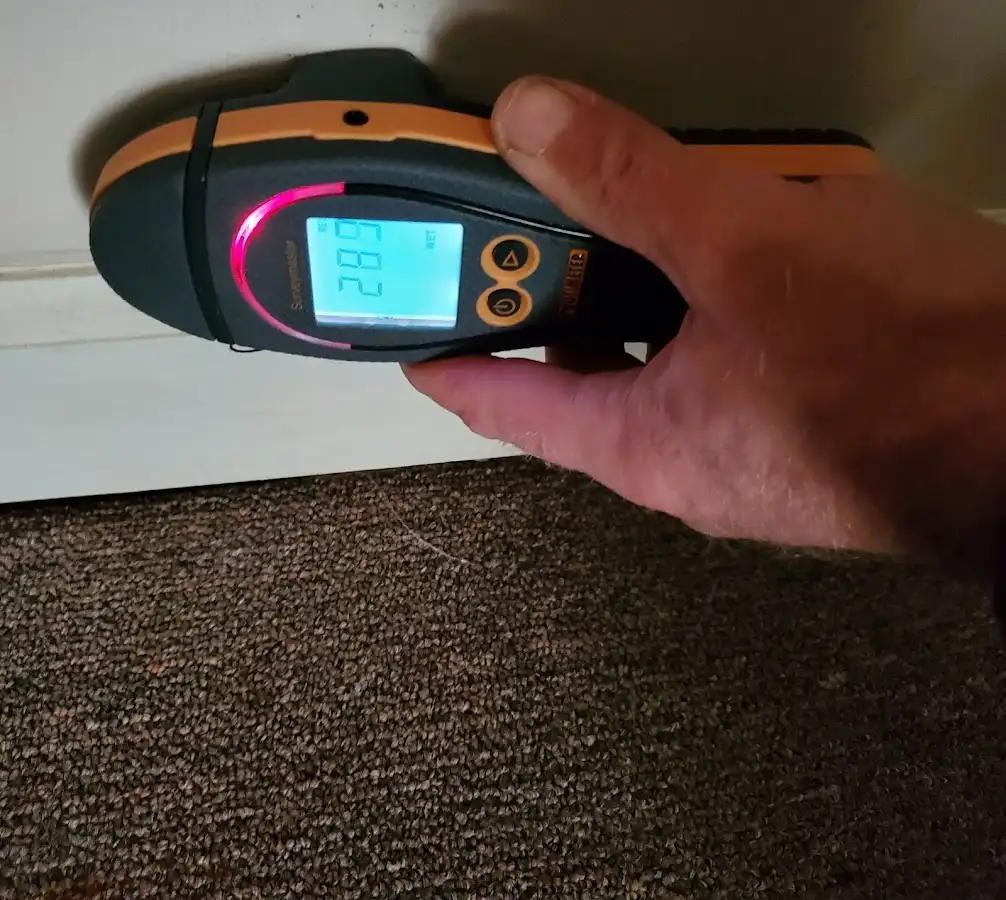 Moisture detection at baseboard during Storm Damage Restoration in Allouez